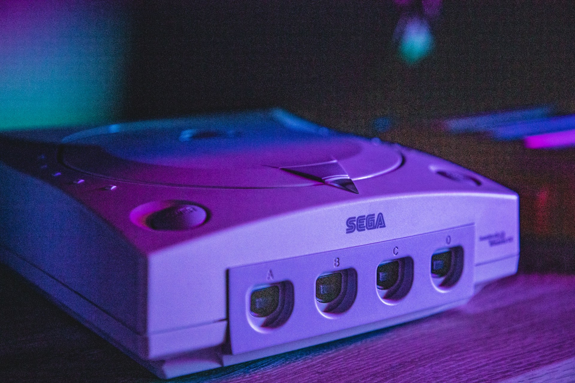 Sega Dreamcast console showing four controller ports with purple and blue lighting
